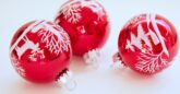 Red baubles with white reindeer patterns on a white background.