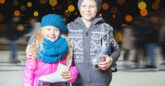 Image of two kids holding ice skating shoes
